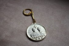 collectible keychain featuring portraits of Emperor Hirohito and Empress Kōjun