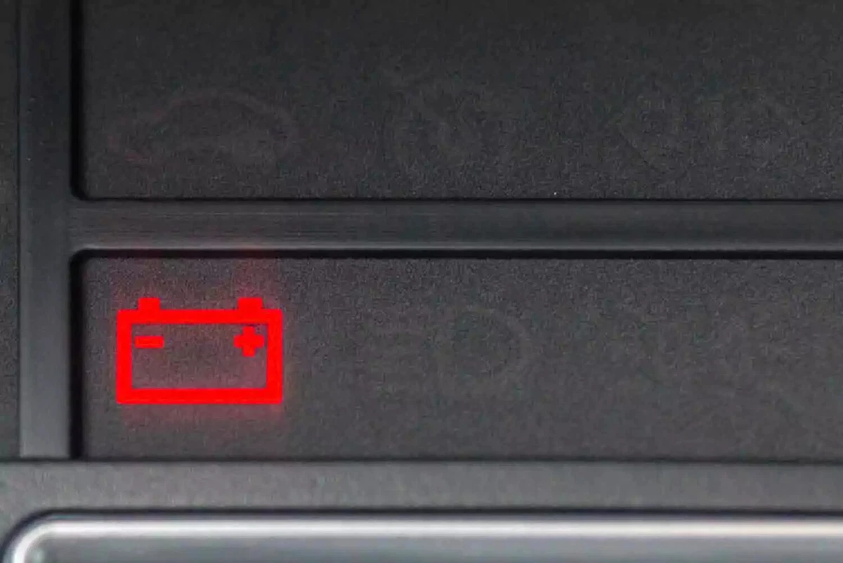 An illuminated battery warning light on a dashboard.