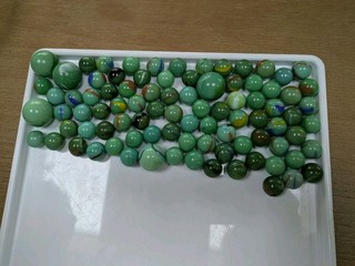 Approximately 80 Green And Coloured Swirl Marbles