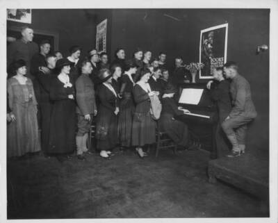 Women & soldiers singing along a piano a makeshift services club d Old Photo
