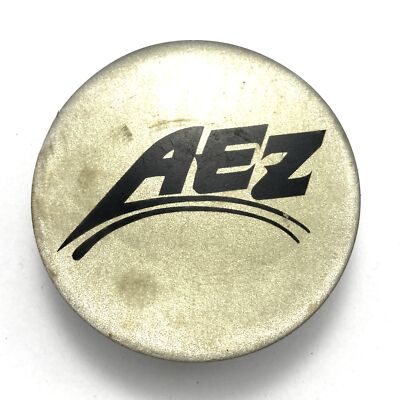 Aftermarket AEZ Silver W/ Yellow Clear Coat Center Cap 2.4'' OD P/N 3B0071213666