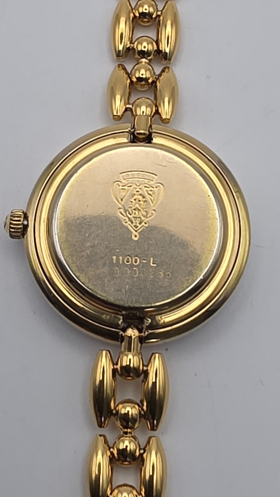 Gucci 1100L  Lady's Gold Plated Bracelet Watch with Six Interchangeable Bezels.