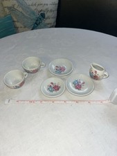 Vintage miniature porcelain tea set featuring a delicate floral rose pattern
