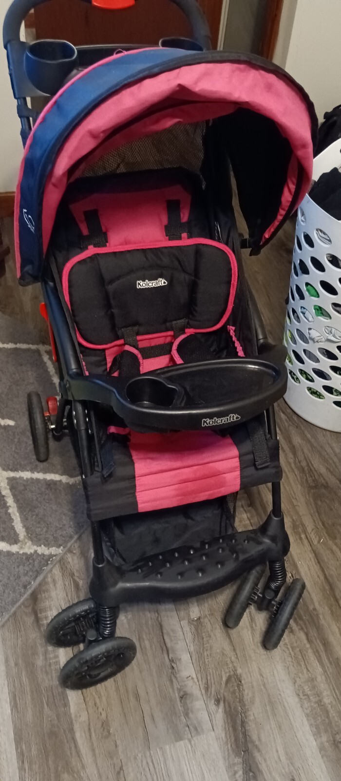 Kolcraft cloud sport lightweight travel stroller in pink and black.