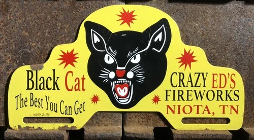 VINTAGE 1967 DATED BLACK CAT CRAZY ED’S FIREWORKS 11” METAL CAR TAG TOPPER SIGN