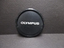 Olympus original 49mm plastic pinch-on front lens cap.