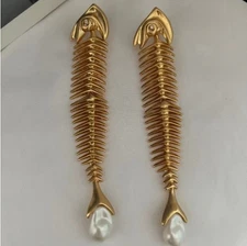 Schiaparelli gold toned fishbone paired with Baroque pearl pendant earrings