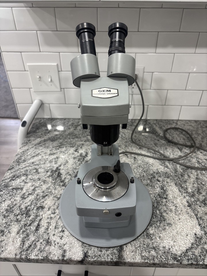A real diamond-grading microscope from Gem Instruments — it's a working piece of the jewelry trade's past, not just a decorative prop.