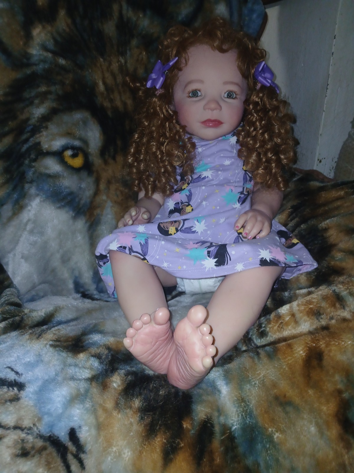 Curly red Haired reborn  Doll in Purple Disney dress.