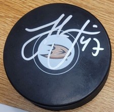 Autographed HAMPUS LINDHOLM Anaheim Ducks Hockey Puck - w / COA