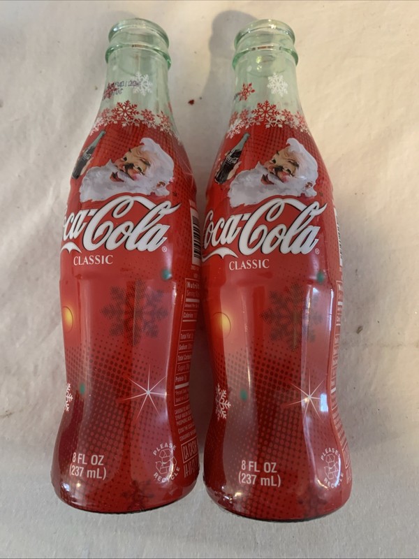 Two Coca-Cola Holiday Glass Bottles