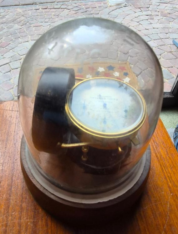 A vintage Dietzen anemometer (wind-speed meter) displayed under a custom dome — already curated into a gorgeous steampunk-adjacent desk artifact.