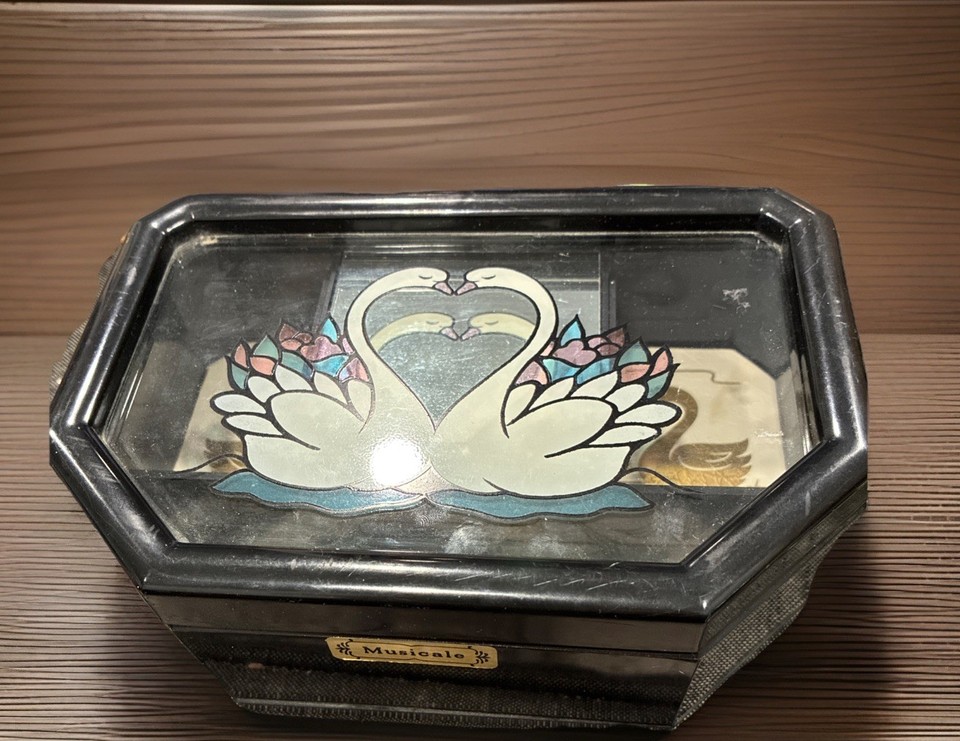 A working vintage swan jewelry music box playing Swan Lake — campy, charming, and the perfect ironic-meets-sincere bedside gift.