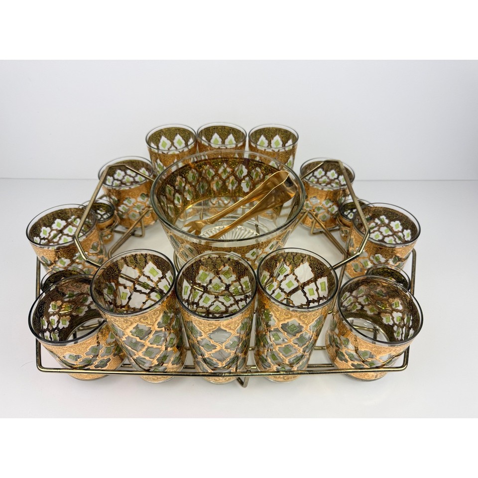 A 17-piece 22K gold-trimmed MCM barware set with caddy — the kind of thing Don Draper would have in his office.