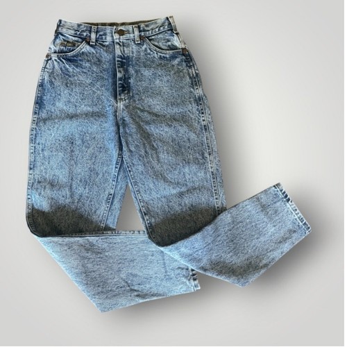 Light blue high-rise vintage Lee jeans size 8 with faded front thighs, five-pocket design, and visible “Made in USA” label.