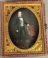 1/4 PLATE DAGUERREOTYPE STANDING GENT, CHAIR W/ RED-COLORED UPHOLSTERY, NO WIPES
