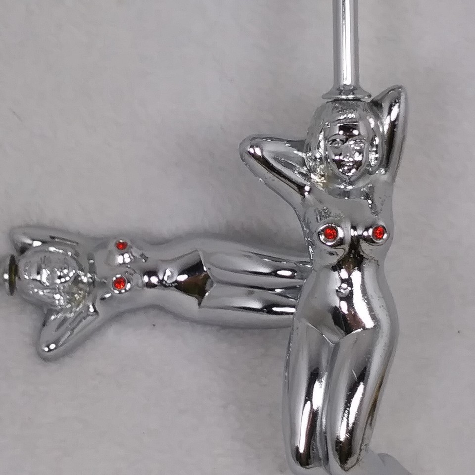 Chrome double jigger with a rhinestone-studded nude woman handle — wildly specific, totally camp, and made in Japan; conversation guaranteed.
