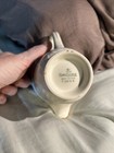 Cream ceramic mug with “Homer Laughlin Made in U.S.A. F50 N6” text on white porcelain base.