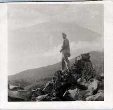 WW2 Photo of Soldier Standing on Rocks, Mountain Background