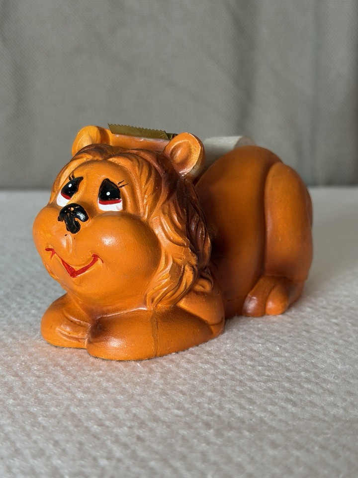 A ceramic lion that dispenses tape — vintage novelty desk accessories this charming and specific are genuinely hard to find.