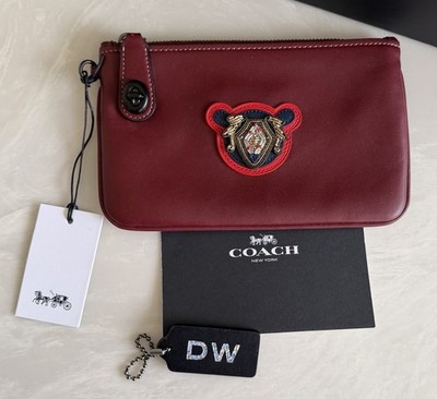 COACH BORDEAUX LEATHER VARSITY PATCH TURNLOCK WRISTLET 21 57180