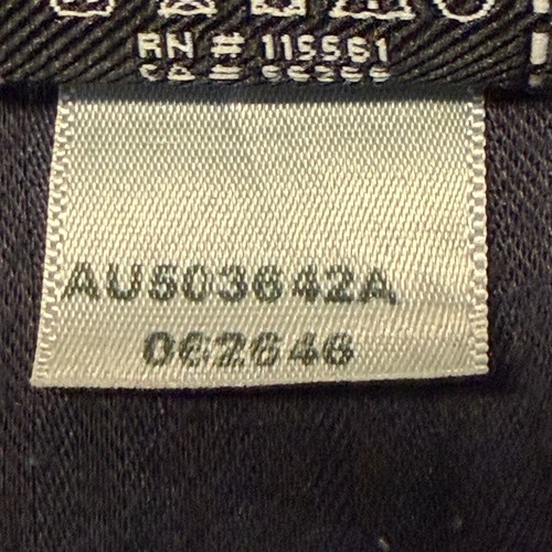 White fabric tag on black 7 For All Mankind denim shorts, size 32, with gray printed code “AU503642A 027264B” and product details.