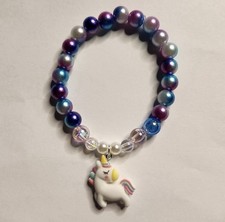 Multicolor beaded plastic bracelet with unicorn charm