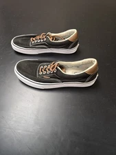 Vans Era 59 sneakers with a black canvas upper and brown leather accents.