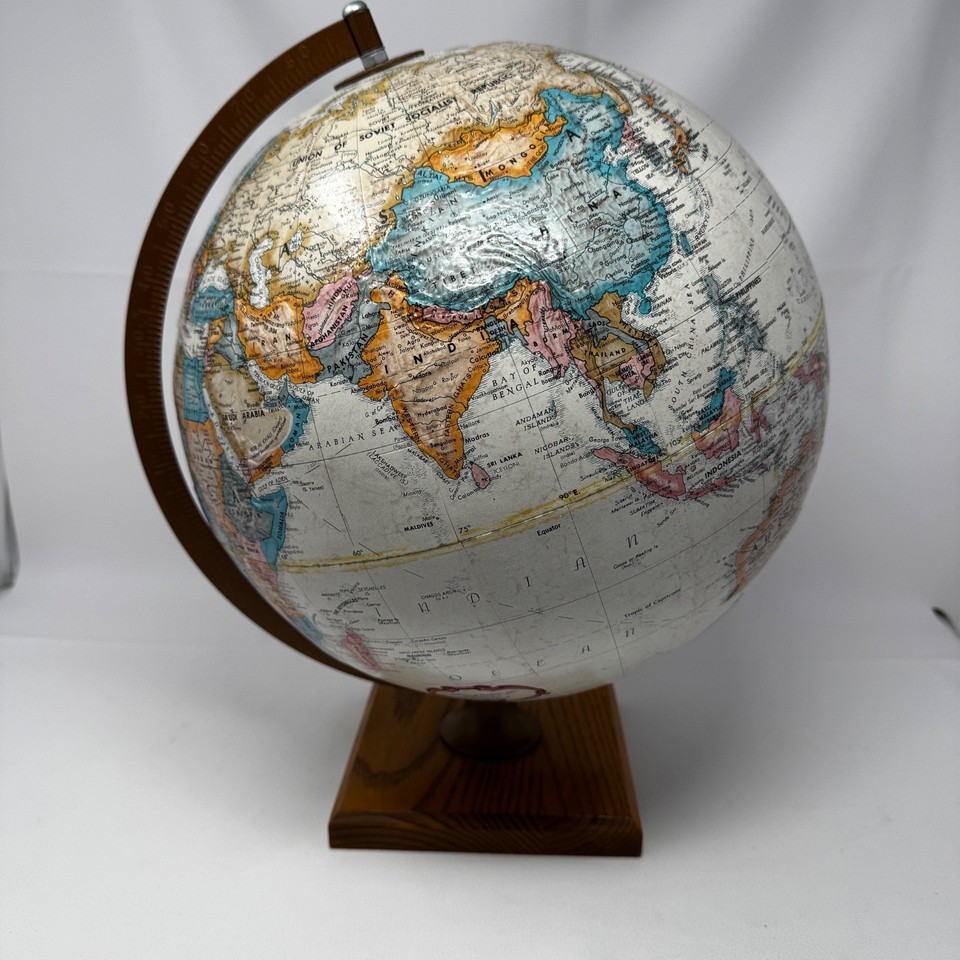 A classic Replogle 12" desktop globe on a wooden base — the kind of authoritative, old-school study piece that makes any bookshelf look smarter.