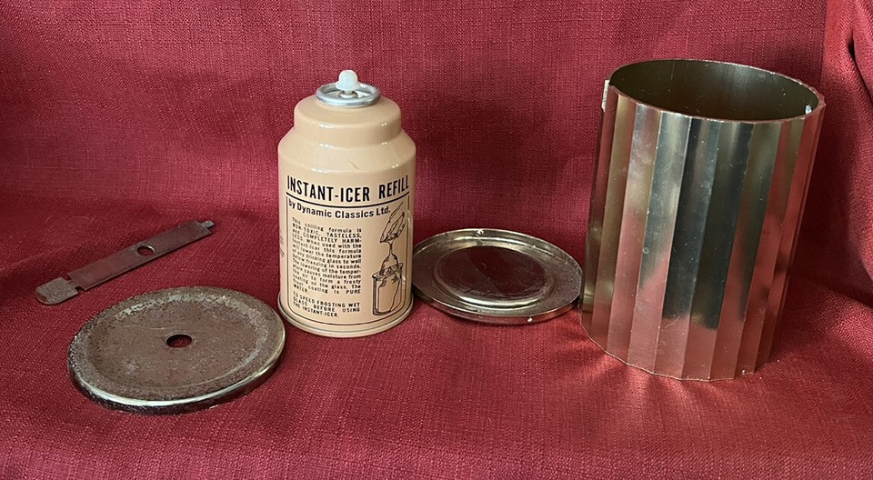 A brass vintage 'Instant Glass Icer' — a genuinely obscure bar gadget that fast-chills glasses, the kind of thing bartenders stopped making and nobody knows existed.