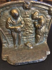 Book ends are bronze bookends of a farmer wife and husband