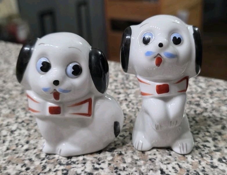 Vintage Japanese big-eye anthropomorphic dog figurines — that wide-eyed, slightly unsettling charm that makes them impossible to put down in a thrift store.