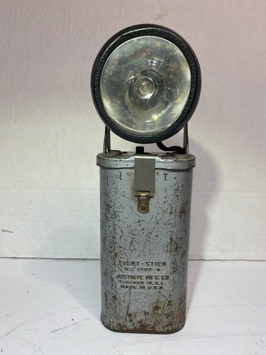 Vintage silver Flashlight Bell System Light-Stick No. 2105-4 by Justrite Mfg. Co. with black metal lens and side label.