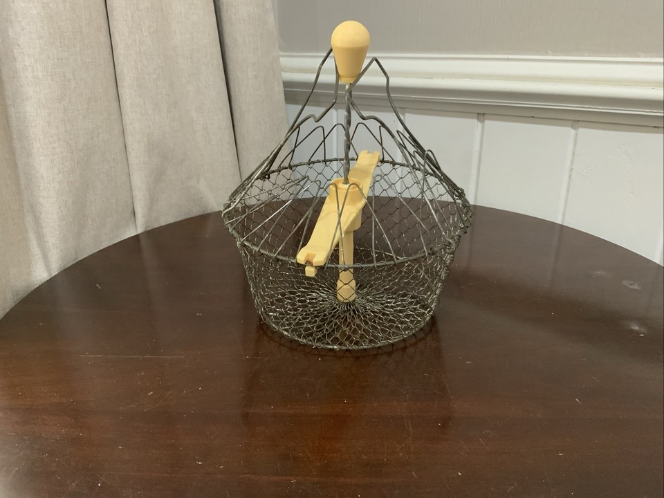 A 19th-century French wire salad spinner ('fil de fer') — a kinetic, sculptural kitchen antique that predates plastic by a century and looks like art on a shelf.