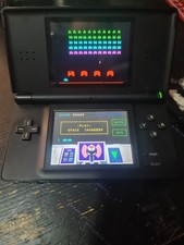 Nintendo DS complete with 2 x TT cards loaded with over 50 games