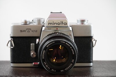 MINOLTA SRT100 35MM CAMERA W/ MINOLTA 50MM WITH SO MANY EXTRAS/ FOR PARTS