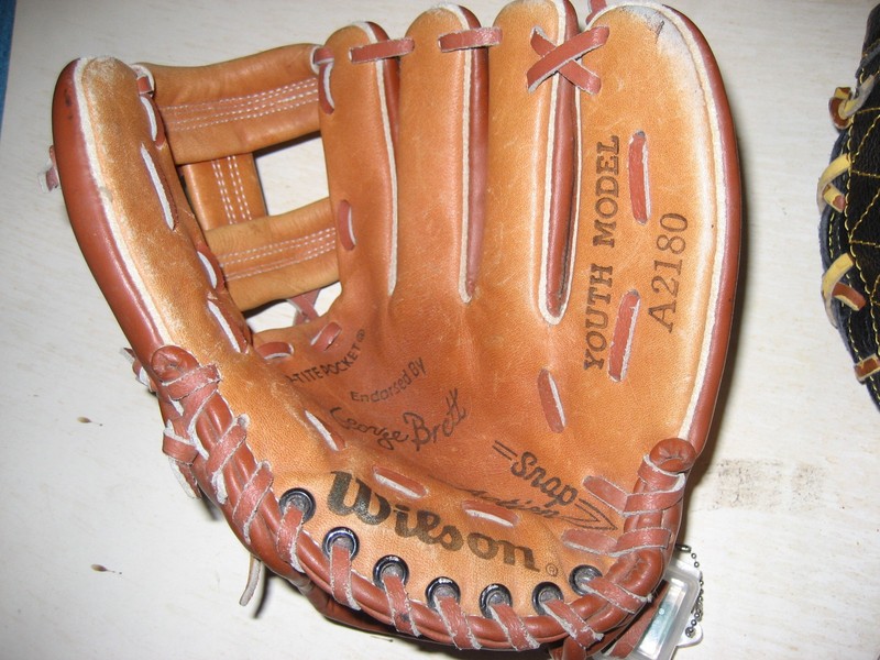 TWO Youth model baseball gloves by Wilson. Very good condition