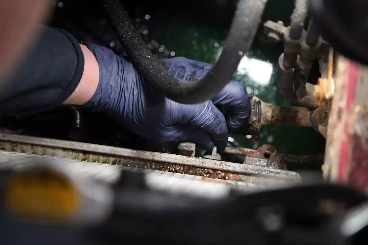 Opening the radiator’s drain port.