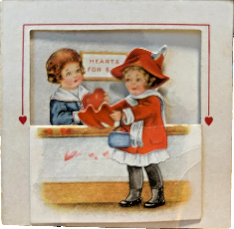 Pop-out vintage valentine: front folds down to show girl buying valentine fr boy