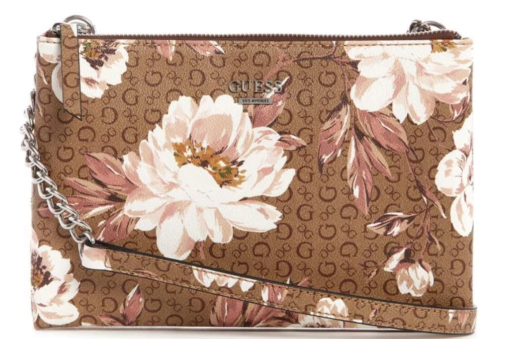 Woman holding brown and pink floral leather crossbody bag photo