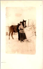 Postcard RPPC Woman Snow Winter Clothes Horse Unknown D179