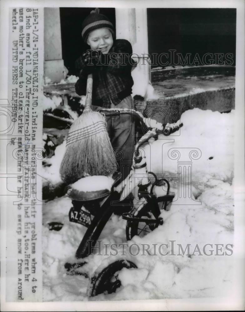 1956 Press Photo Danny Fairbank sweeps snow off her bike in Indianapolis Indiana
