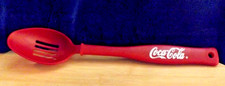 13 IN RED PLASTIC SLOTTED SERVING SPOON FEATURES COCA COLA BOTTLE SHAPED HANDLE