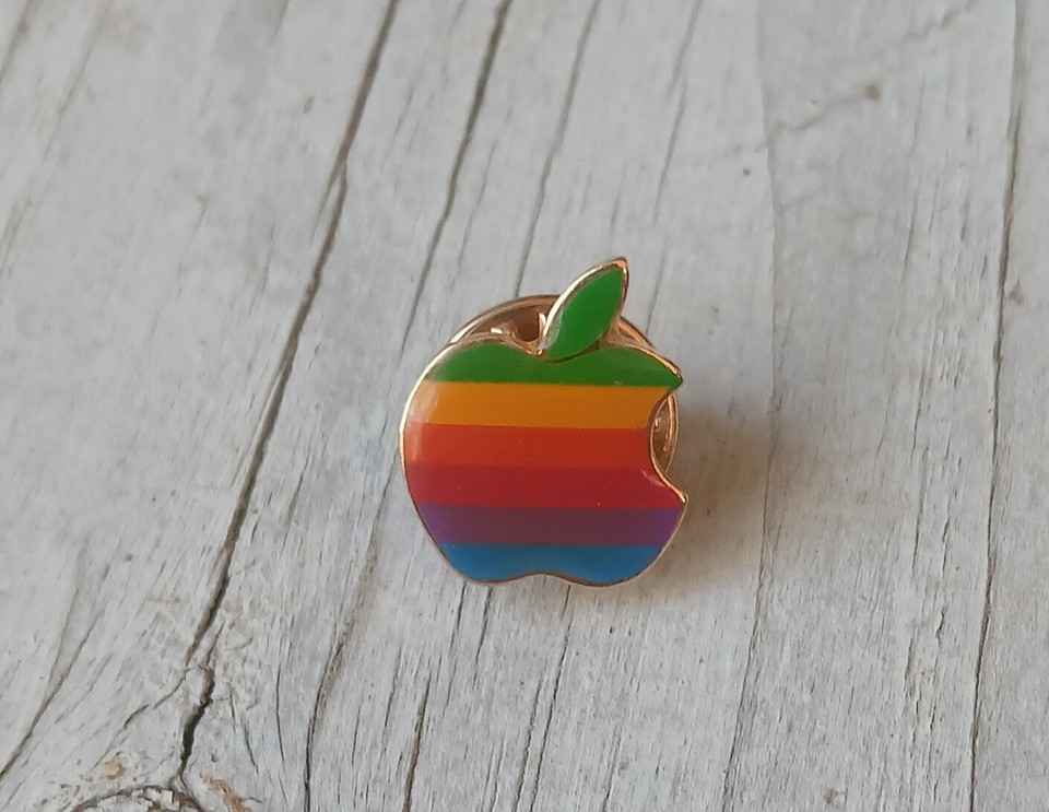 A rainbow Apple Macintosh enamel lapel pin styled after the iconic 1980s logo — tiny, wearable nostalgia for anyone who worshipped at the altar of early Mac.