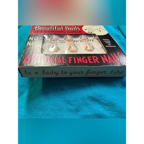 Brown artificial finger nails in box labeled “NU-NAILS” with black text and white label reading “Be a lady to your finger tips.”