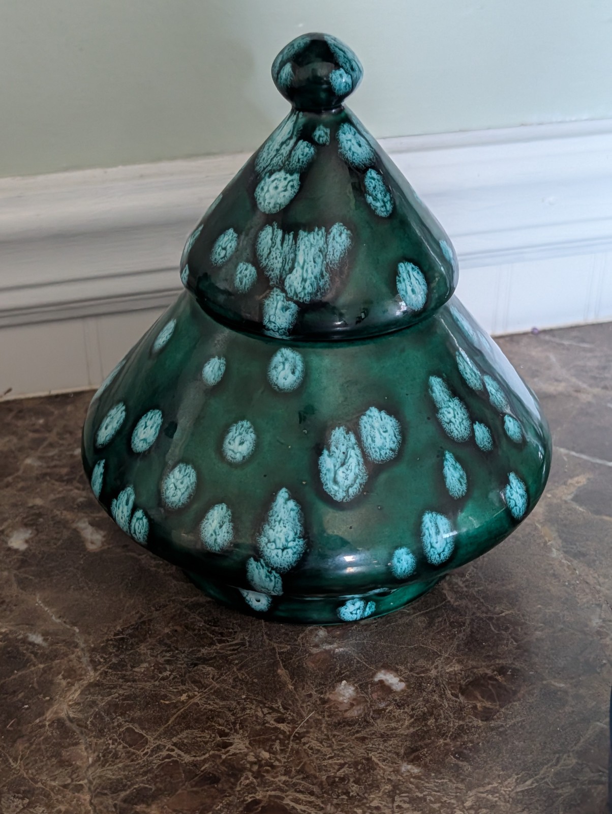 Green ceramic cookie jar with turquoise crystalline drip glaze in a tiered tree shape.