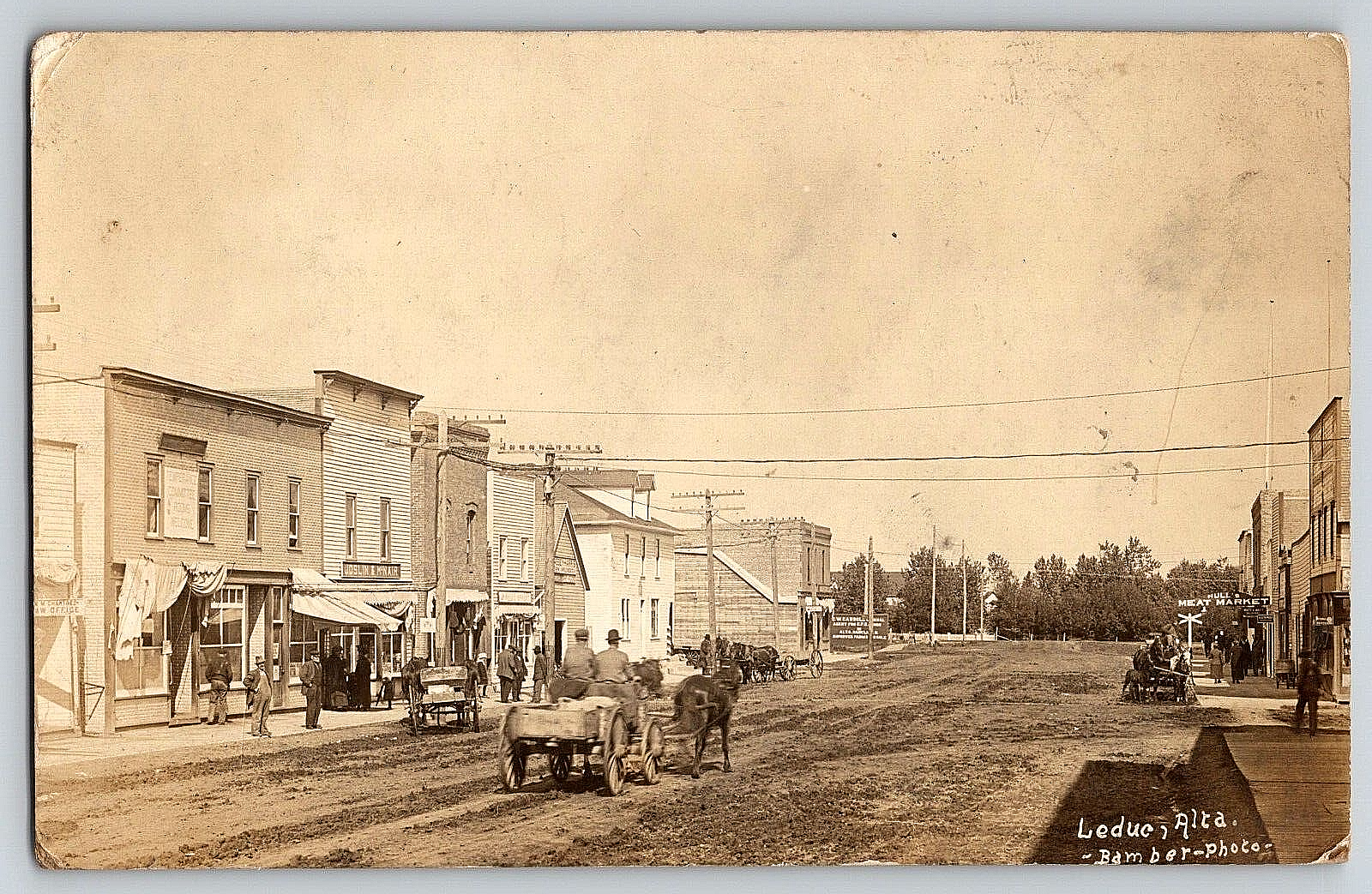 RPPC VINTAGE OLD POSTCARD REAL PHOTO CITY STREET STORES HORSE WAGON LEDUC CANADA