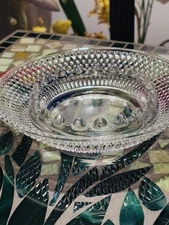 A vintage clear glass ashtray featuring a textured diamond-point pattern