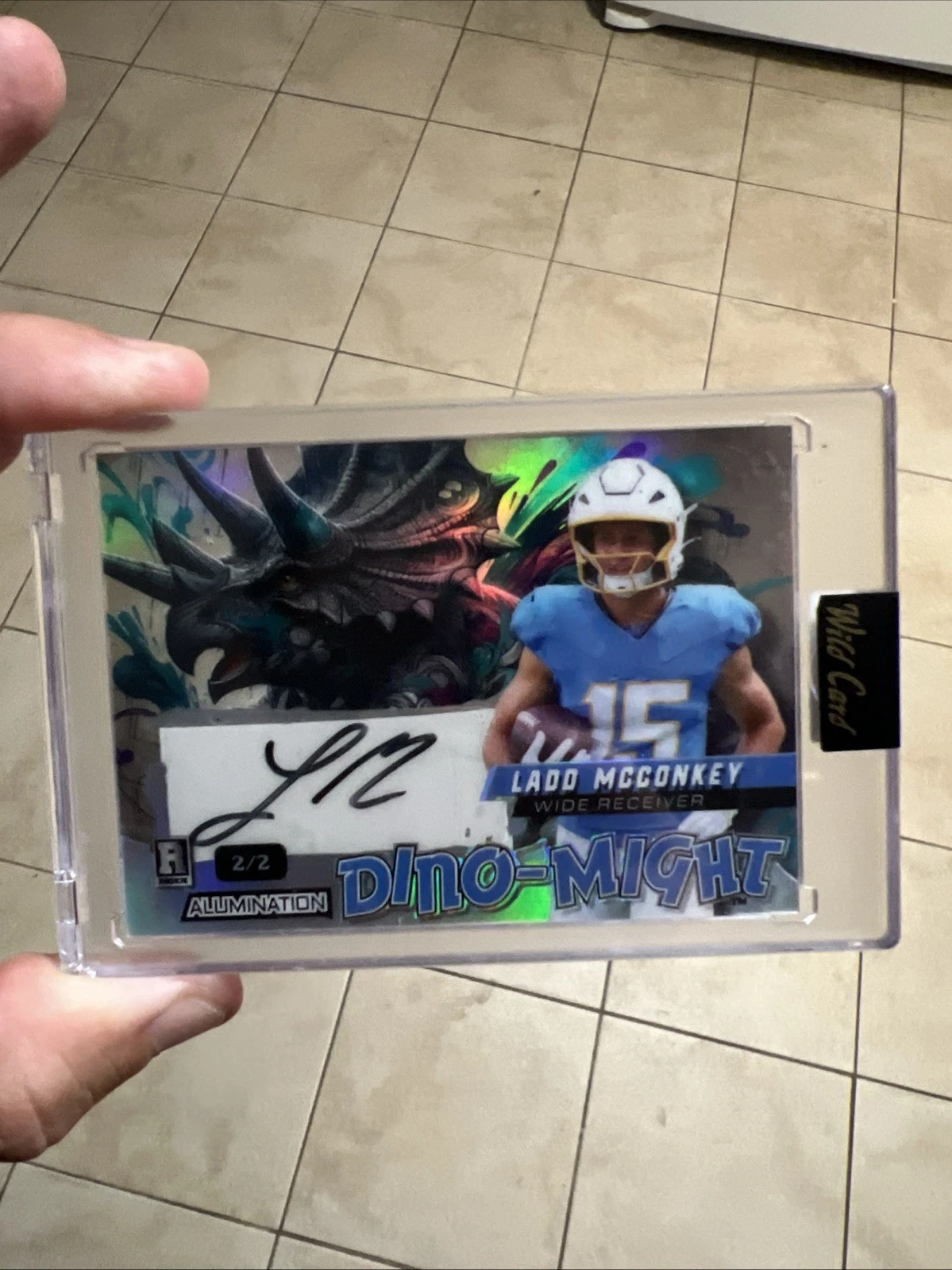 Ladd McConkey Wild Card Alumination Dino-Might Autographs #LMA Tyrannosaurus Rex-Rainbow Foil-White 1/1