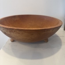 A mid-century hand-turned maple wood bowl featuring a three-footed base design.